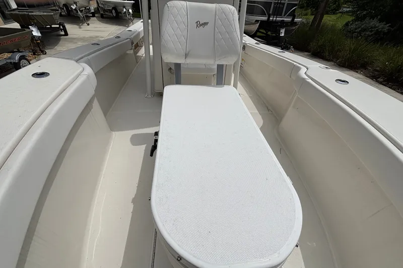 Slide: The Image of 2024 Ranger 2600 Bay boat interior with white seating and spacious deck layout. - 8