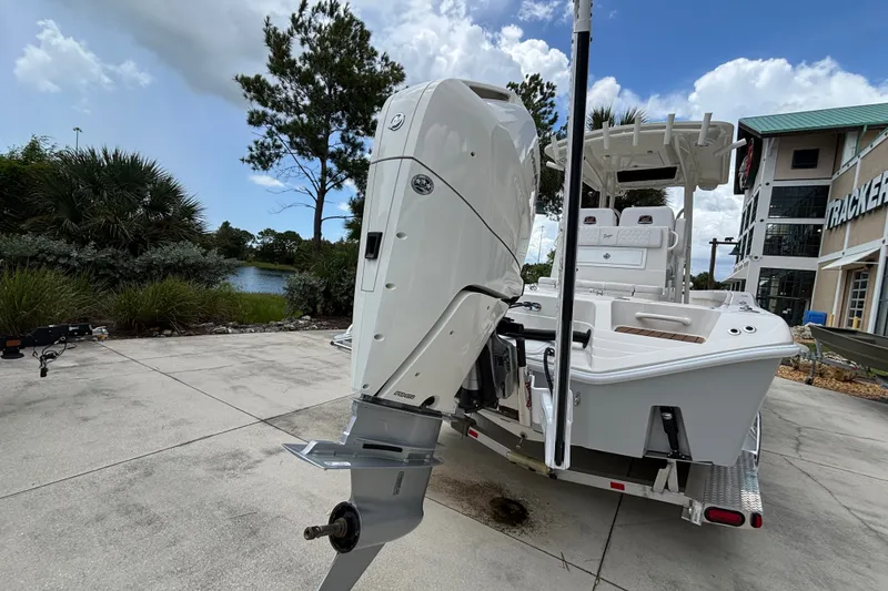 Slide: The Image of 2024 Ranger 2600 Bay boat with powerful outboard motor, parked outdoors. - 3