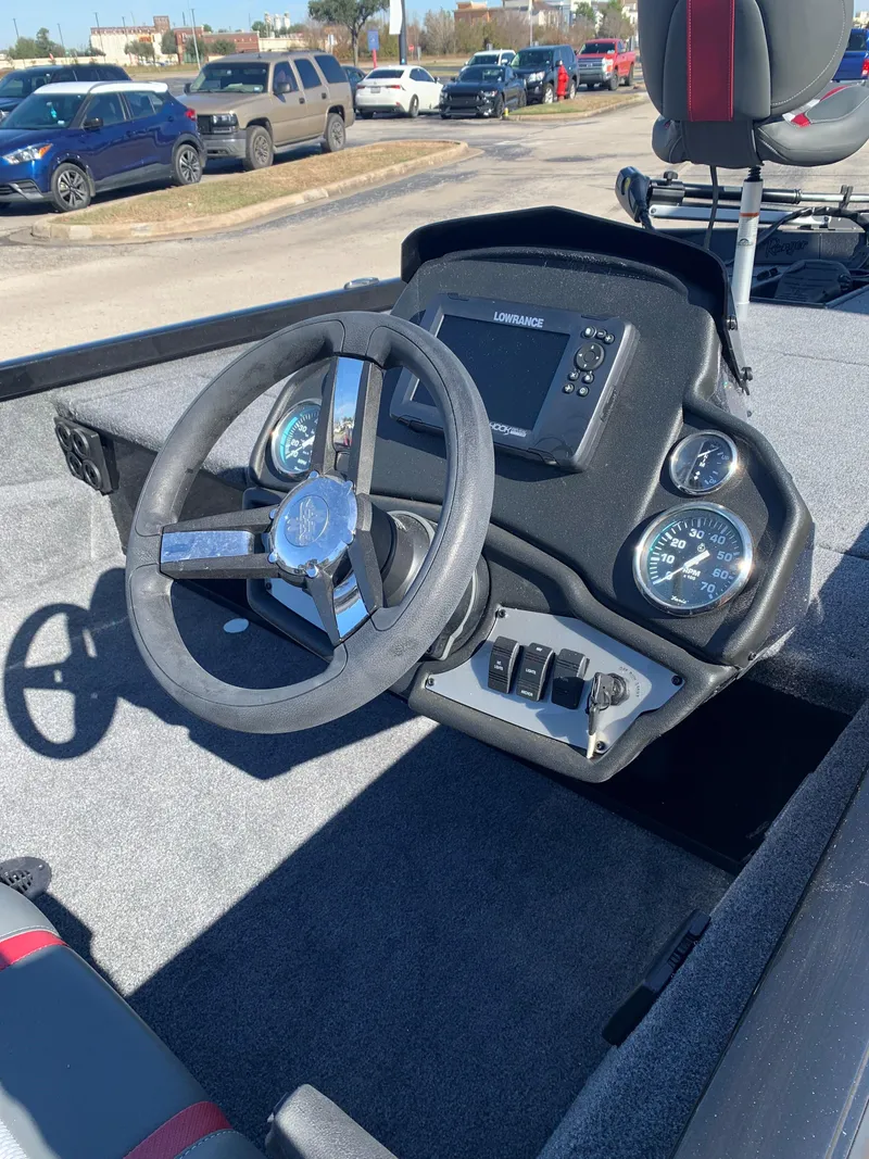 Slide: The Image of 2024 Ranger RT188 boat dashboard with steering wheel and gauges. - 2