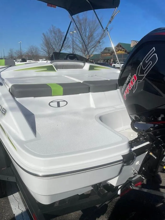 Slide: The Image of 2024 Tahoe T18 boat with sleek design and powerful engine, parked outdoors. - 3