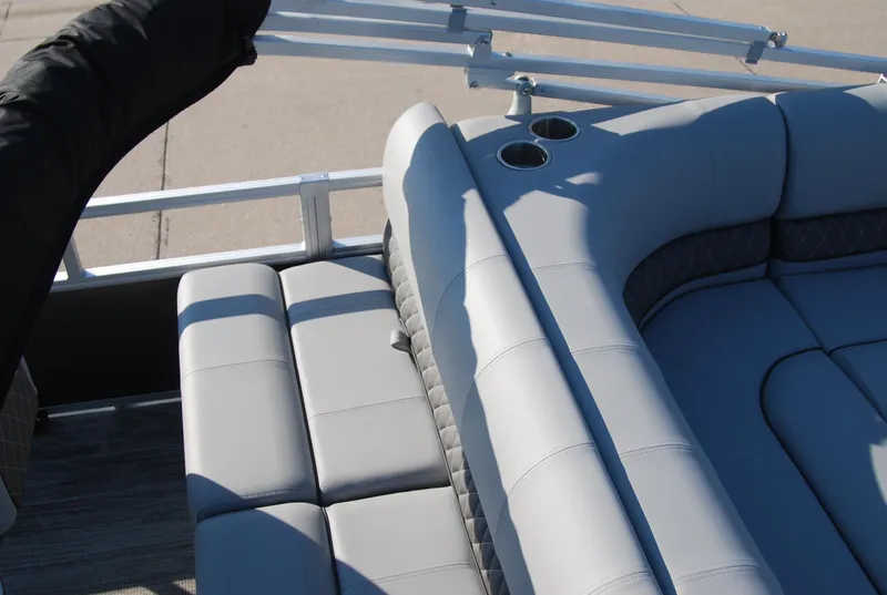 Slide: The Image of 2024 Ranger Reata 220F boat interior with gray seating and cup holders. - 11