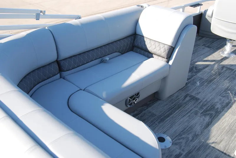 Slide: The Image of 2024 Ranger Reata 220F boat interior with gray cushioned seating and wood-style flooring. - 12
