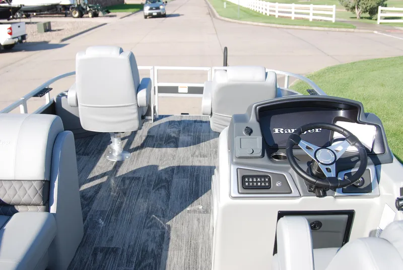 Slide: The Image of 2024 Ranger Reata 220F boat interior with steering console and seating. - 13