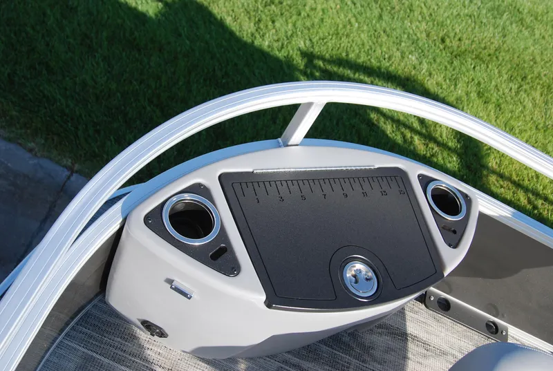 Slide: The Image of 2024 Ranger Reata 220F boat console with cup holders and measurement panel. - 14