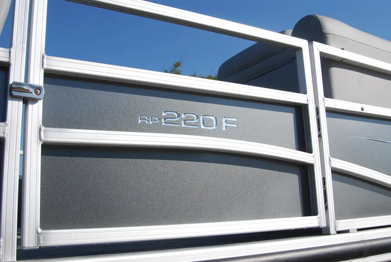 Slide: The Image of 2024 Ranger Reata 220F pontoon boat side view with model emblem. - 16