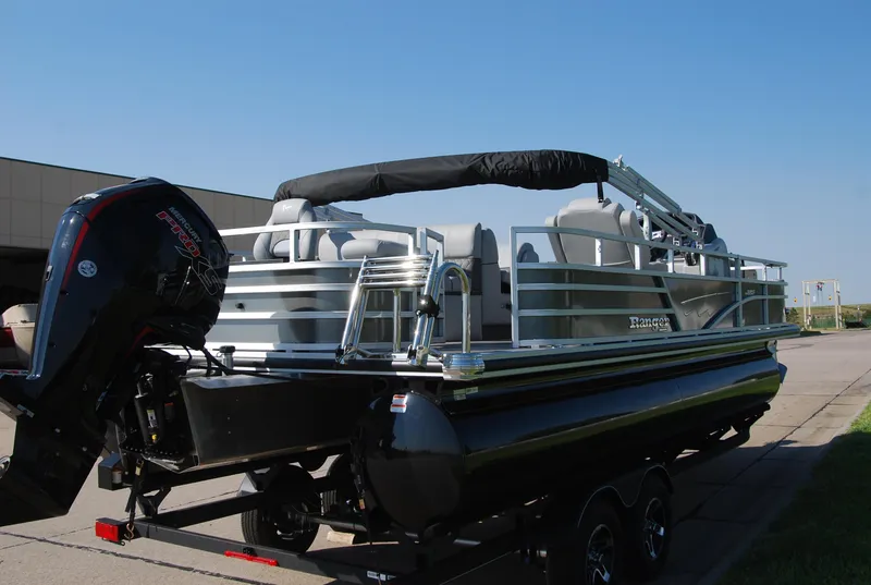 Slide: The Image of 2024 Ranger Reata 220F pontoon boat on trailer, featuring sleek design and powerful outboard motor. - 4