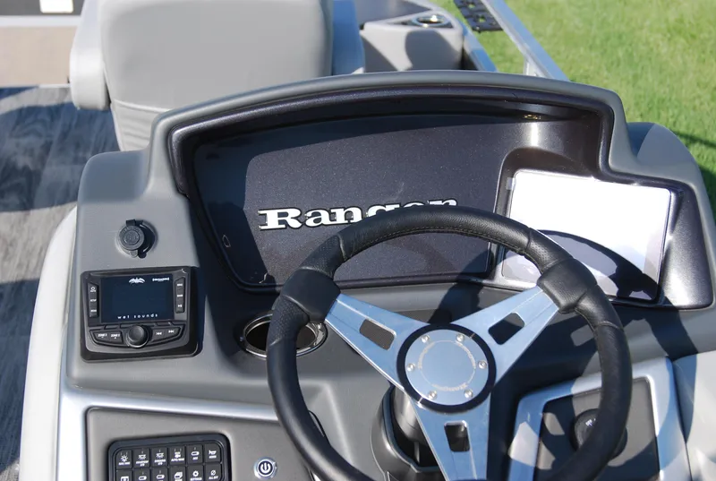 Slide: The Image of 2024 Ranger Reata 220F boat dashboard with steering wheel and controls. - 6
