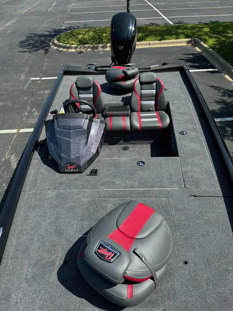 Slide: The Image of 2024 Ranger RT178C fishing boat with gray and red seating in a parking lot. - 4