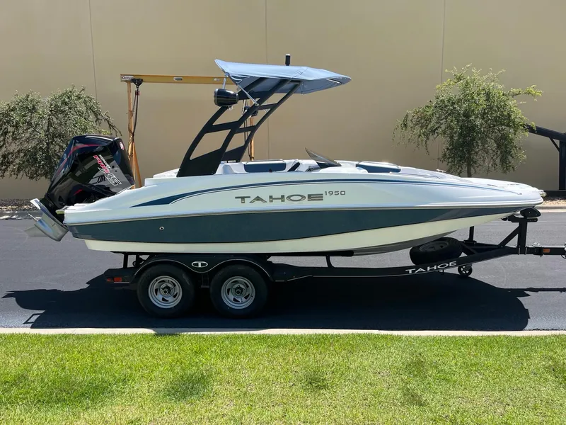 Slide: The Image of 2024 Tahoe 1950 boat on trailer, sleek design, parked outdoors. - 1