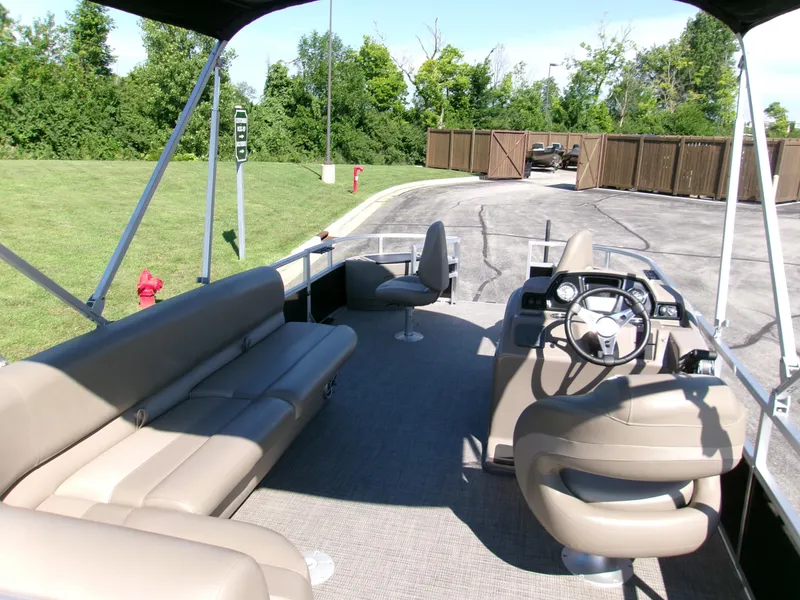 Slide: The Image of 2024 Ranger Reata 200F pontoon boat interior with seating and steering console. - 4