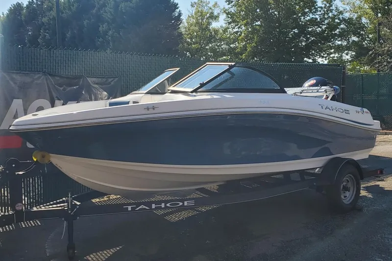 Slide: The Image of 2024 Tahoe 185 S boat on trailer, parked outdoors. - 0