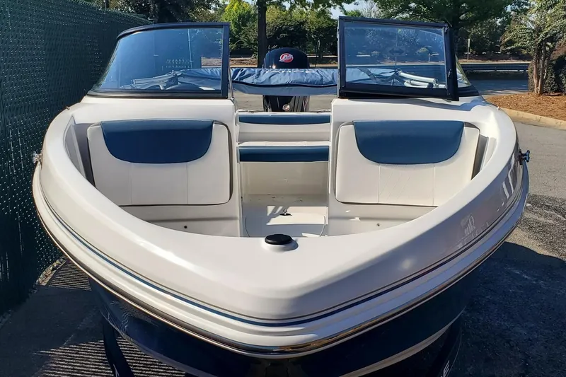 Slide: The Image of 2024 Tahoe 185 S boat with open bow seating, parked outdoors. - 1