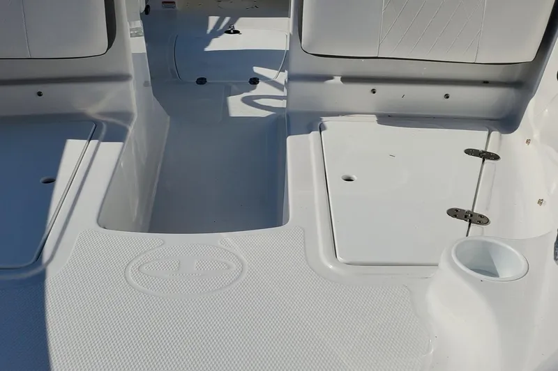 Slide: The Image of 2024 Tahoe 185 S boat interior with white seating and storage compartments. - 30