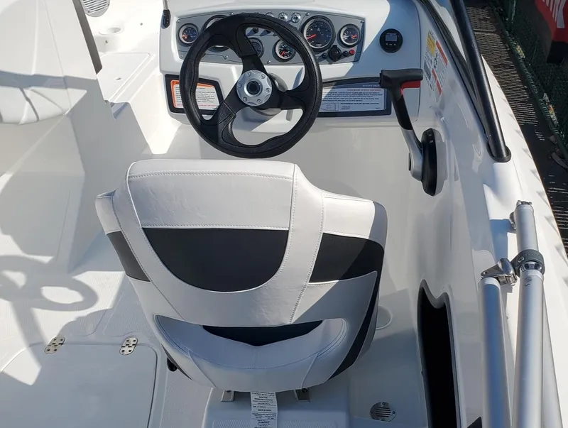 Slide: The Image of 2024 Tahoe 185 S boat cockpit with steering wheel and white seat. - 33