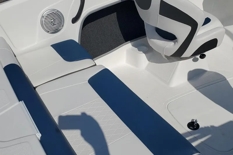Slide: The Image of 2024 Tahoe 185 S boat interior with white and blue seating and speaker. - 34