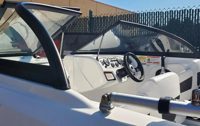 Slide: The Image of 2024 Tahoe 185 S boat interior with steering wheel and dashboard. - 35