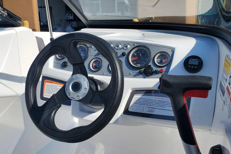 Slide: The Image of 2024 Tahoe 185 S boat dashboard with steering wheel and gauges. - 36