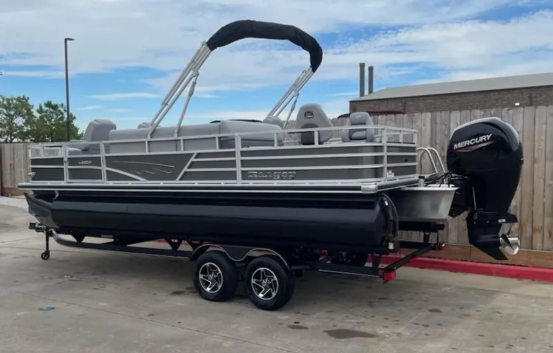 Slide: The Image of 2024 Ranger Reata 220F pontoon boat on trailer with Mercury outboard motor. - 2