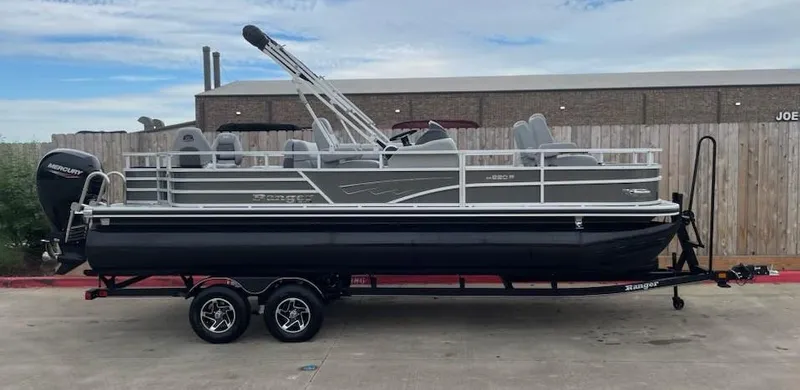 Slide: The Image of 2024 Ranger Reata 220F pontoon boat on trailer, parked outdoors. - 5