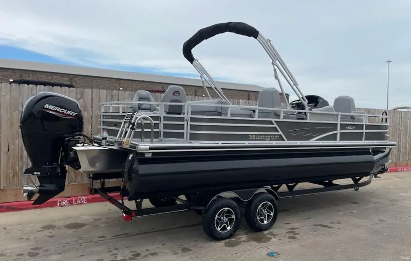 Slide: The Image of 2024 Ranger Reata 220F pontoon boat with Mercury engine on trailer. - 4