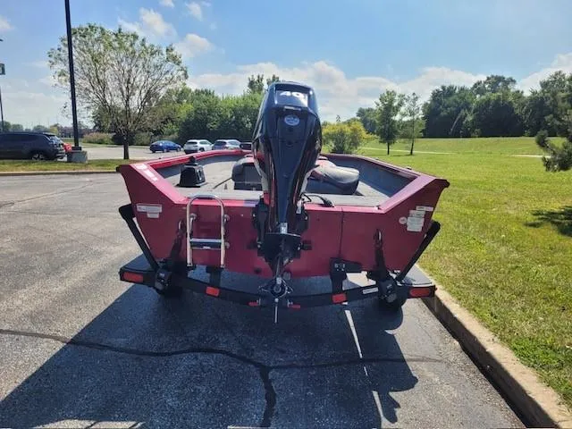 Slide: The Image of 2024 Ranger VS1665T boat, red, parked outdoors on a sunny day. - 3