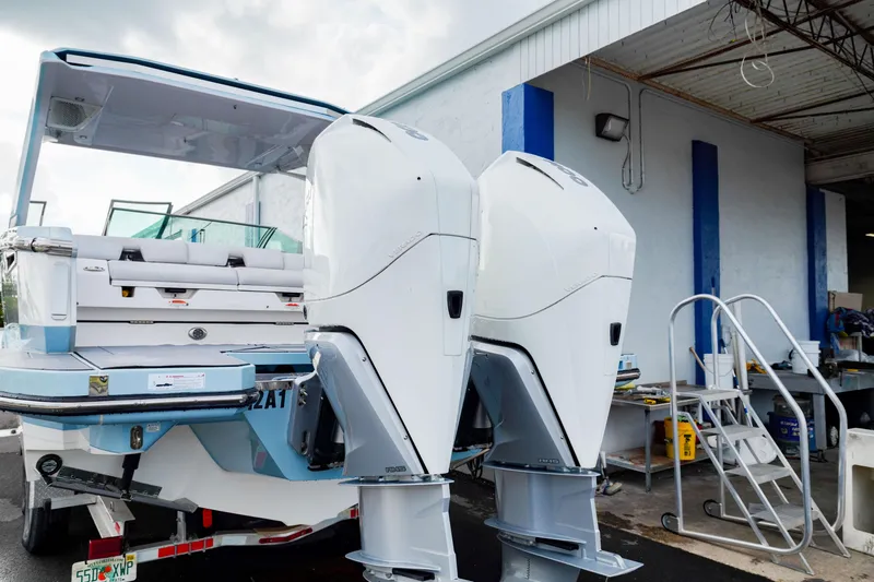 Slide: The Image of 2022 Aviara AV32 OB boat with dual outboard engines at a marina. - 10