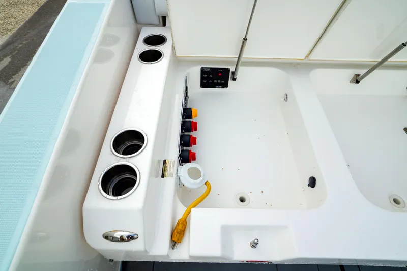 Slide: The Image of Aviara AV32 OB 2022 boat deck with cup holders and control panel. - 15