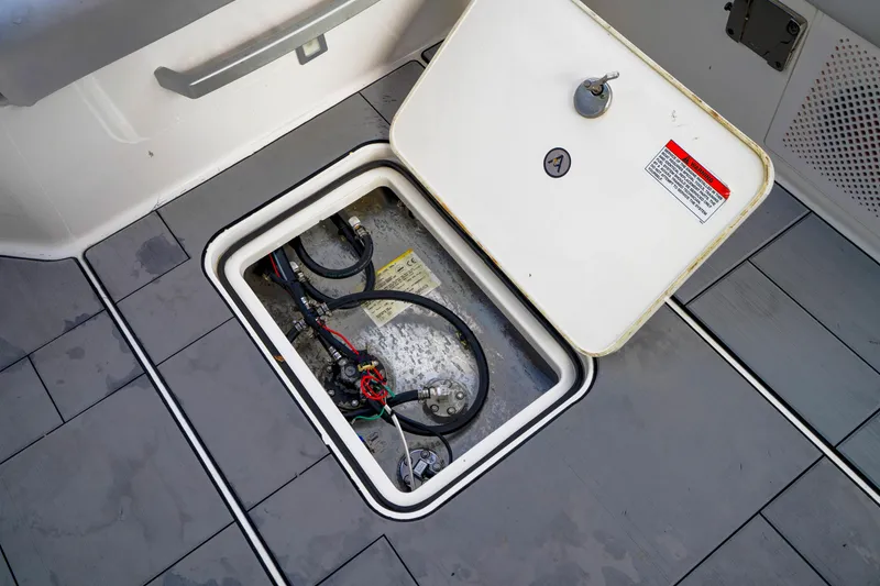 Slide: The Image of Open hatch on 2022 Aviara AV32 OB boat deck, revealing internal wiring. - 24
