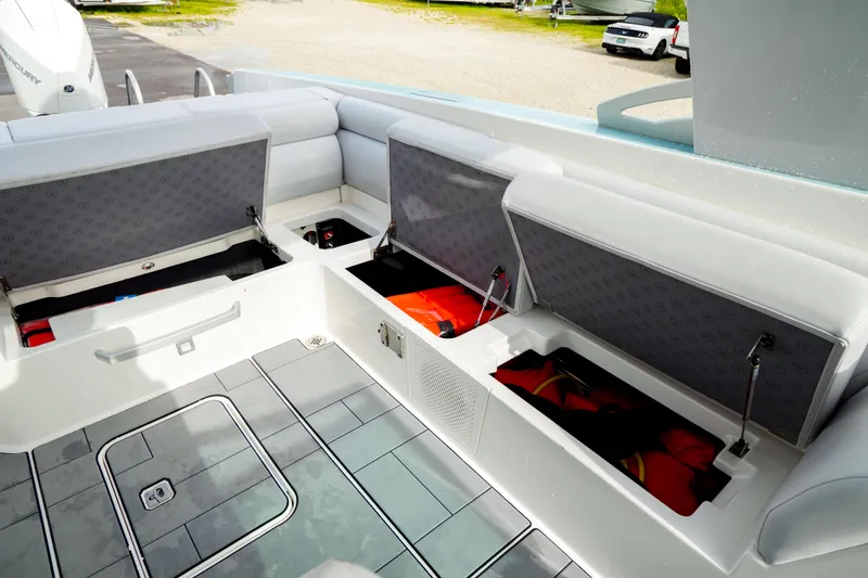 Slide: The Image of 2022 Aviara AV32 OB boat interior with open storage compartments and life jackets. - 25
