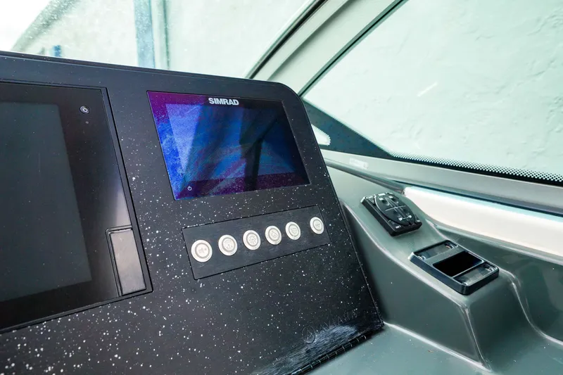 Slide: The Image of 2022 Aviara AV32 OB dashboard with Simrad display and control panel. - 31