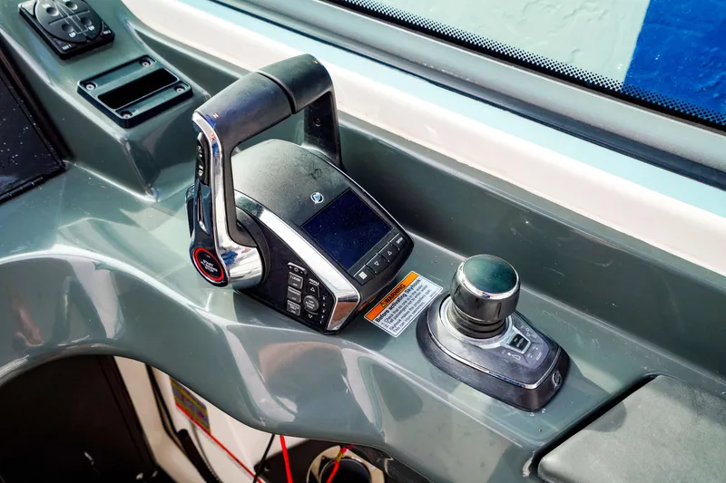 Slide: The Image of 2022 Aviara AV32 OB boat control panel with joystick and throttle. - 33