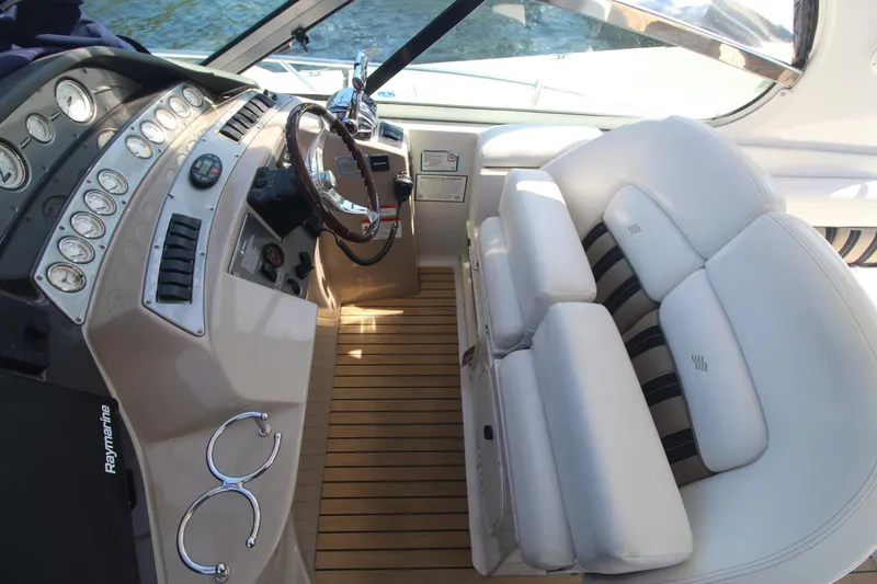 Slide: The Image of 2006 Four Winns 378 Vista boat cockpit with steering wheel and plush seating. - 18