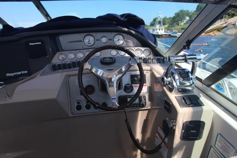 Slide: The Image of 2006 Four Winns 378 Vista boat dashboard with steering wheel and control panel. - 20