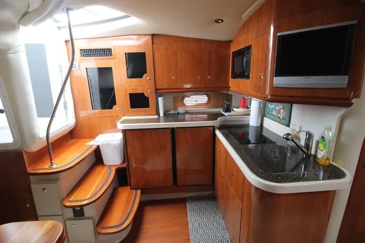 Slide: The Image of Interior of 2006 Four Winns 378 Vista yacht with modern kitchen amenities. - 23