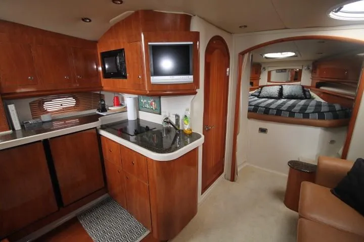 Slide: The Image of 2006 Four Winns 378 Vista yacht interior with kitchen and cozy bedroom. - 25