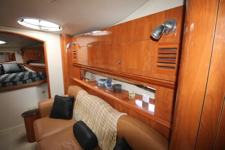 Slide: The Image of Interior of 2006 Four Winns 378 Vista yacht with wood cabinetry and cozy seating area. - 27