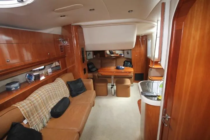 Slide: The Image of Interior of 2006 Four Winns 378 Vista yacht with cozy seating and wooden finishes. - 30