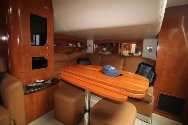 Slide: The Image of Interior of 2006 Four Winns 378 Vista yacht with wooden table and leather seating. - 31