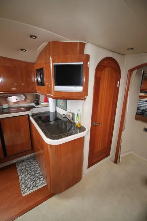Slide: The Image of Interior of 2006 Four Winns 378 Vista yacht with kitchenette and wooden cabinetry. - 35