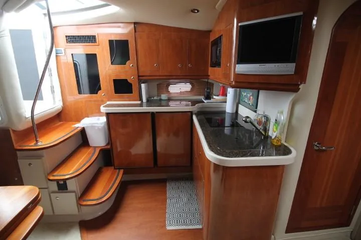 Slide: The Image of Luxurious 2006 Four Winns 378 Vista yacht interior with modern kitchen and wooden cabinetry. - 36