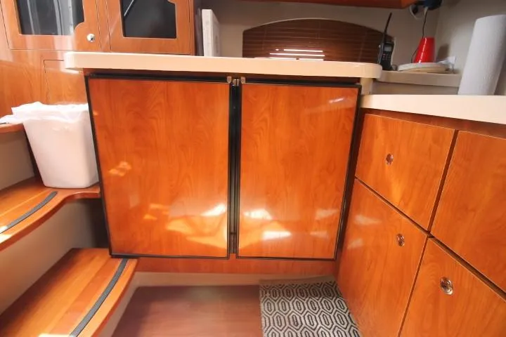 Slide: The Image of 2006 Four Winns 378 Vista yacht interior with wooden cabinetry and steps. - 44