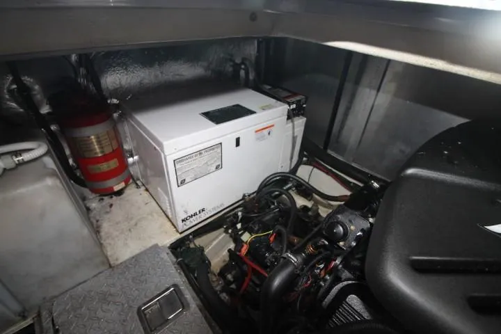 Slide: The Image of Engine room of 2006 Four Winns 378 Vista with generator and fire extinguisher. - 48