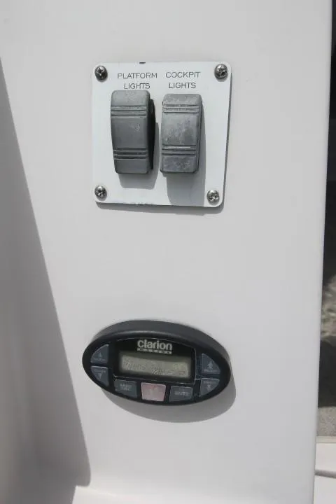 Slide: The Image of Control panel with switches and Clarion display on 2006 Four Winns 378 Vista boat. - 8