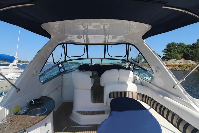 Slide: The Image of 2006 Four Winns 378 Vista boat interior with seating and kitchenette on a sunny day. - 9