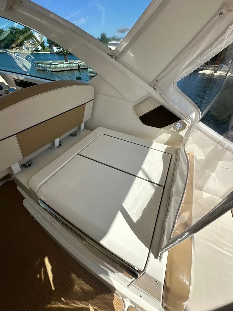 Slide: The Image of 2014 Tiara Yachts 3100 Coronet interior with beige seating and water view. - 10