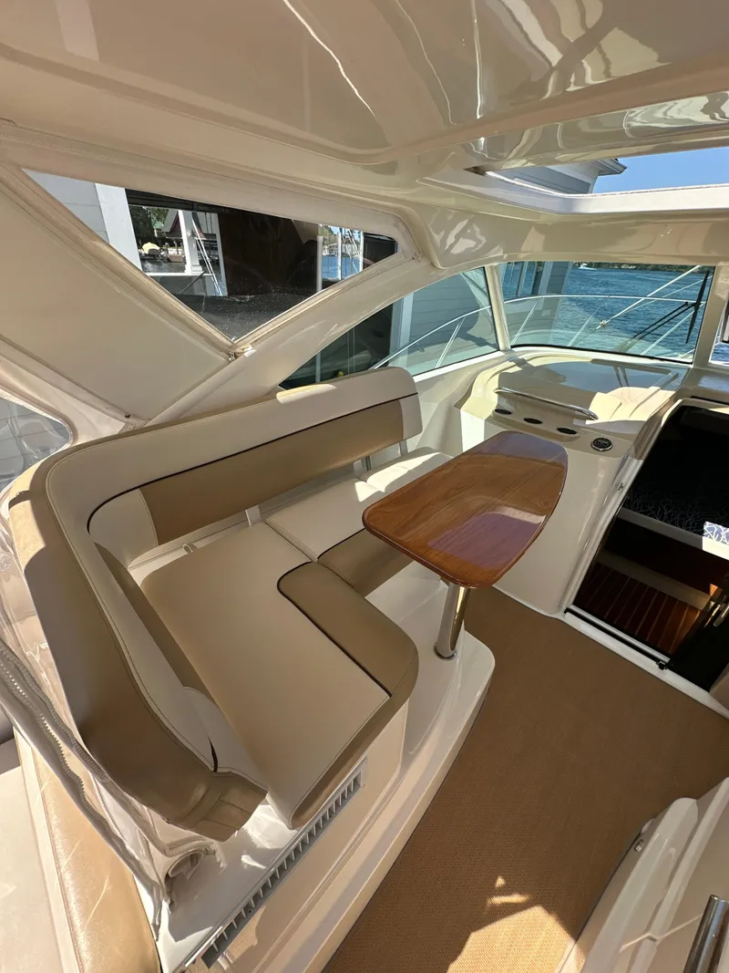 Slide: The Image of 2014 Tiara Yachts 3100 Coronet interior with seating and table, showcasing luxury design. - 13