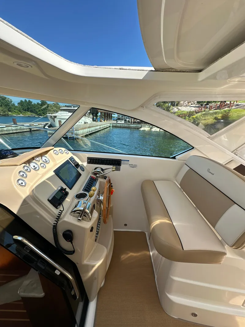 Slide: The Image of 2014 Tiara Yachts 3100 Coronet interior with helm, seating, and water view. - 14