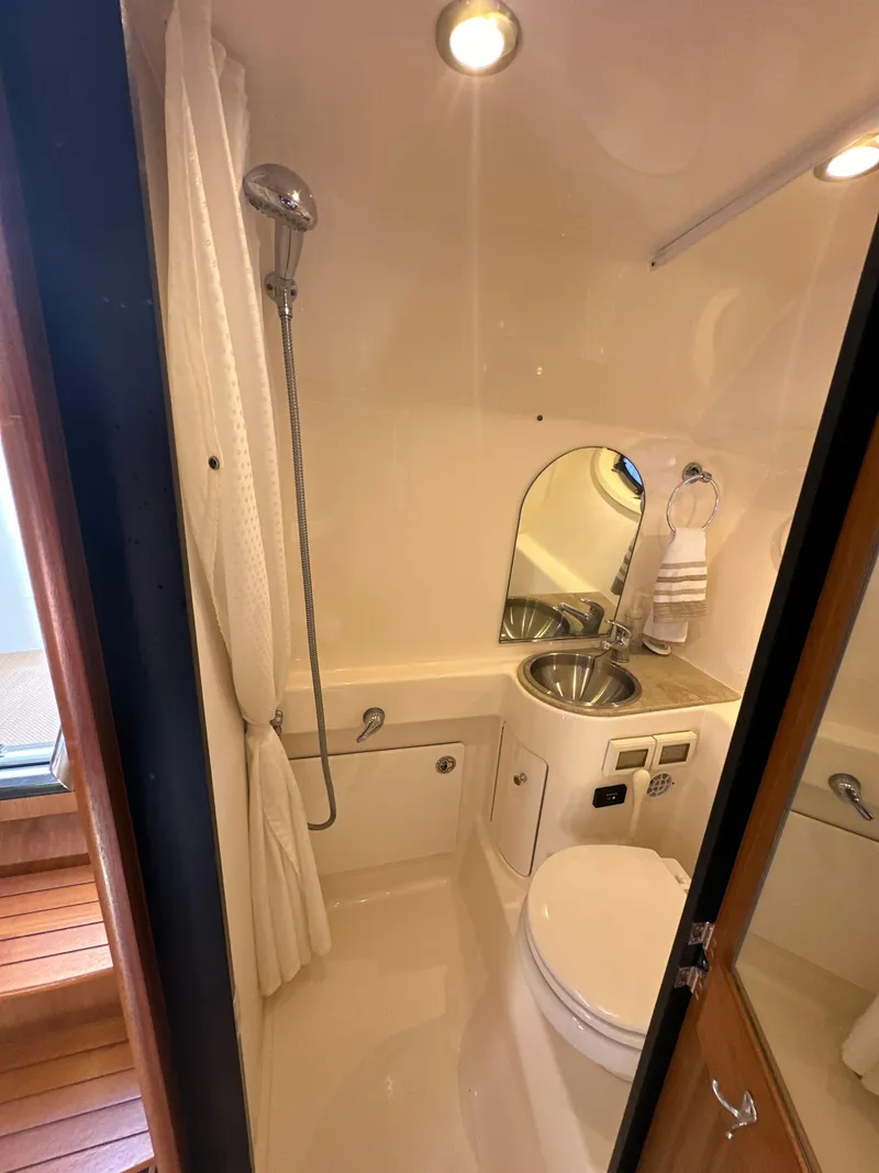 Slide: The Image of 2014 Tiara Yachts 3100 Coronet bathroom with shower, sink, and toilet. - 20