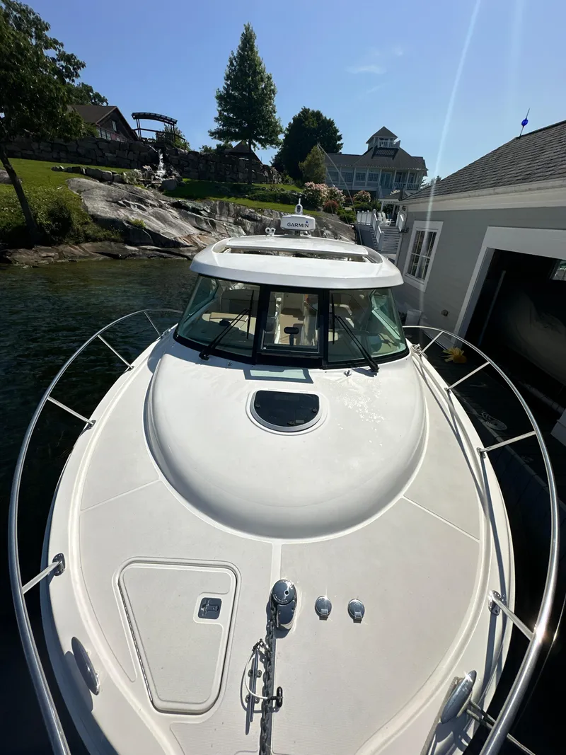 Slide: The Image of 2014 Tiara Yachts 3100 Coronet docked near waterfront homes. - 3