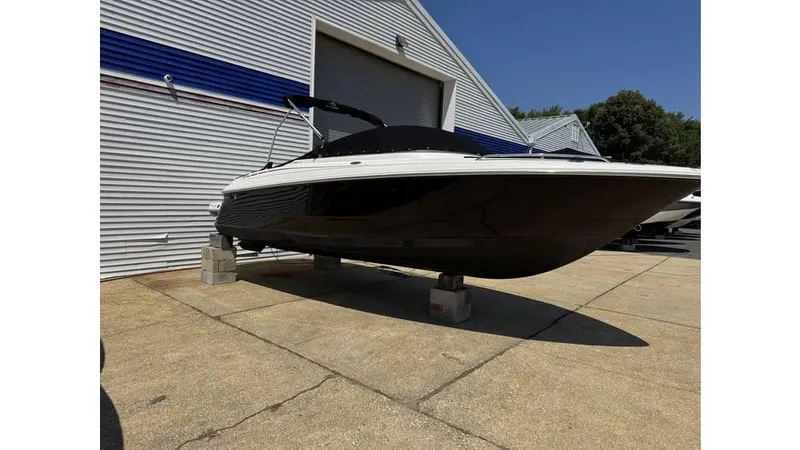 The Image of 2007 Monterey 234FS boat on display outside a warehouse. - 1